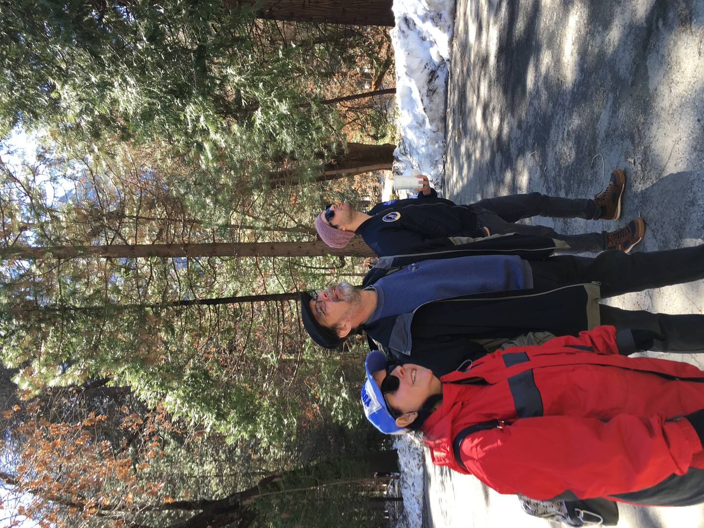 The author admiring views at Yosemite Falls with her husband and son.