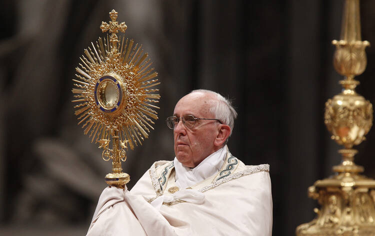 Pope Francis leads the Benediction following eucharistic adoration in St. Peter's Basilica at the Vatican June 2. Catholics gathered at the same time for eucharistic adoration in cathedrals and parishes around the world for the first Vatican-organized global holy hour. (CNS photo/Paul Haring)