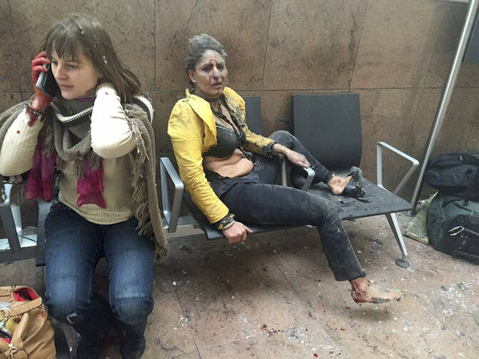 Injured people are seen at the scene of explosions at Zaventem airport near Brussels March 22. (CNS photo/Reuters, handout)