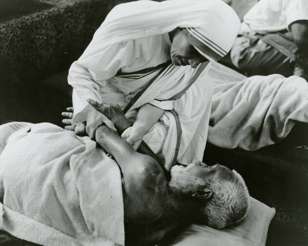 Blessed Teresa of Kolkata cares for a sick man in an undated photo. (CNS photo/KNA)