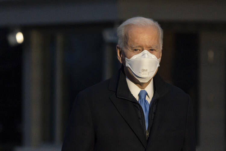 President Joe Biden pauses to speak with reporters as he walks to Marine One for departure from the South Lawn of the White House, Friday, Feb. 12, 2021, in Washington. 