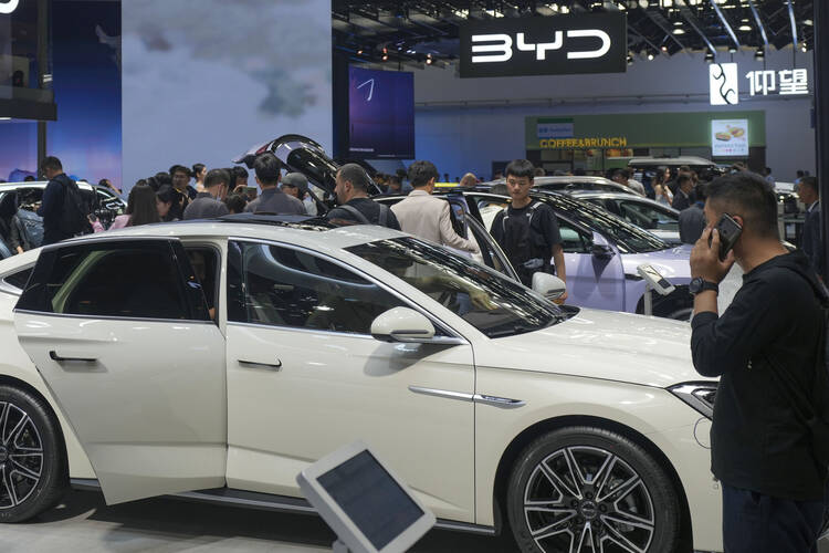Visitors look at several electric vehicles on display at the China Auto Show in Beijing, China, on April 26, 2024. The United States and Europe may be able to punish China economically be raising tariffs on Chinese-made cars, but there are environmental costs to a trade war. (AP Photo/Tatan Syuflana, File)