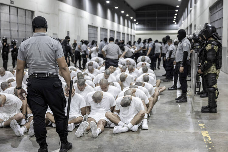 In this photo provided by El Salvador's presidential press office, a prison guard transfers deportees from the U.S., alleged to be Venezuelan gang members, to the Terrorism Confinement Center in Tecoluca, El Salvador, March 16, 2025. (El Salvador presidential press office via AP, File)