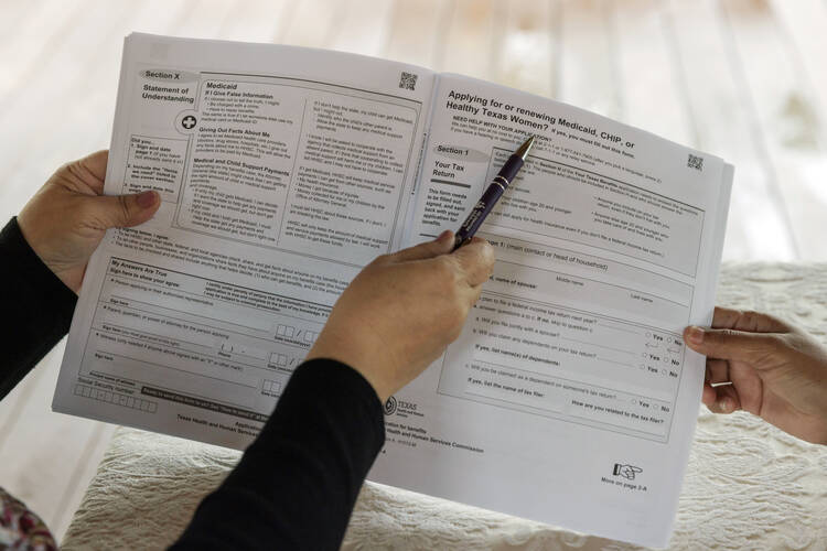 A woman in Texas receives assistance in filling out Medicaid and SNAP application forms. Increased paperwork and red tape can have the effect of discouraging even those eligible for Medicaid from applying for it. (AP Photo/Michael Gonzalez, File)