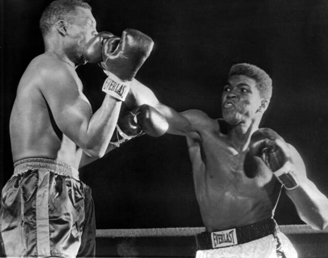 Muhammad Ali (Cassius Clay), right, lands on Don Warner's jaw in an early exchange of their fight in Miami Beach, Fla., Feb. 28, 1962 (AP Photo).