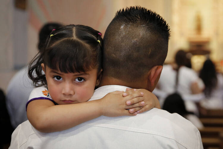 A child attends a special Mass at Mission San Miguel in San Miguel, Calif., May 16 (CNS photo/Nancy Wiechec).