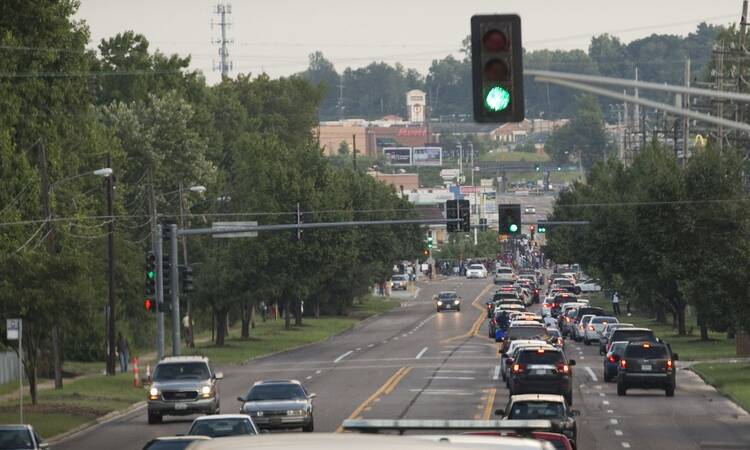 Protesters attempt to close a busy road in Ferguson, Mo., Aug. 11. The area has been the epicenter of rioting following the Aug. 9 shooting and killing of unarmed teenager Michael Brown by a police officer. (CNS photo/Lisa Johnston, St. Louis Review)