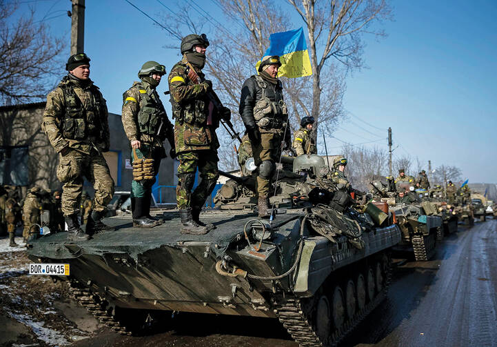 IDENTITY CRISIS. Ukrainian armed forces ride on armored personnel carriers near Debaltseve, Ukraine, Feb. 12.