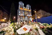 Tributes to the dead are seen outside of Notre Dame Basilica in Nice, France, Nov. 1, 2020, as French bishops conduct a "penitential rite of reparation," following the Oct. 29 deadly attack at church. (CNS photo/Lionel Urman, Panoramic via Reuters)