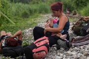 A migrant feeds her child during a pause along a railroad track in Sayula de Aleman, Mexico, Aug. 22, 2024, during their journey toward the U.S. border. (OSV News photo/Angel Hernandez, Reuters)