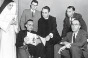 The Rev. Andrew M. Greeley, seated left, talks with fellow speakers following a symposium on "New Horizons in Catholic Thought" in 1962.