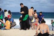 BEACH READING: A priest reads the Bible as he waits for the arrival of Pope Francis on Copacabana Beach during World Youth day in Rio de Janeiro on July 26.