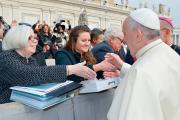 READING MATERIAL. Saint Mary’s College President Carol Ann Mooney, left, and Saint Mary’s student Kristen Millar, center. President Mooney is holding a binder with all the letters addressed to Pope Francis.