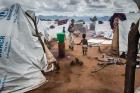 Refugees walk outside their tents in early February 2016 in the Kapise refugee camp in Mwanza, Malawi. (CNS photo/Erico Waga, EPA