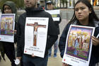 People hold signs during a candlelight prayer vigil Dec. 8, 2019, held to oppose the Trump administration's plan to reinstate the federal death penalty. (CNS photo/David Maung)