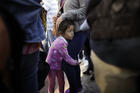 Nicole Hernandez, of the Mexican state of Guerrero, holds on to her mother as they wait with other families in Tijuana, Mexico, on June 13 to request political asylum in the United States. (AP Photo/Gregory Bull, file)