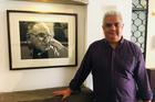 Nery Rodenas, director of the Human Rights Office of the Archdiocese of Guatemala, stands beside a portrait of Bishop Juan José Gerardi. (Jackie McVicar)