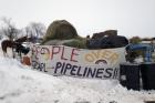 Hay is stacked up to feed horses at a protest encampment along the route of the Dakota Access oil pipeline near Cannon Ball in southern North Dakota on Tuesday, Jan. 24, 2017. President Donald Trump on Tuesday issued an executive action to advance construction of the pipeline, which opponents believe threatens drinking water and cultural sites. The pipeline developer disputes that. (AP Photo/James MacPherson)